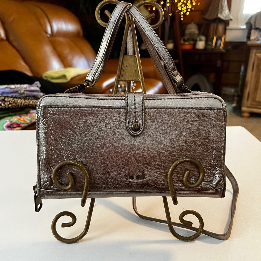 The Sak Leather Chic Metallic Pewter Women’s Cross Body Wallet.